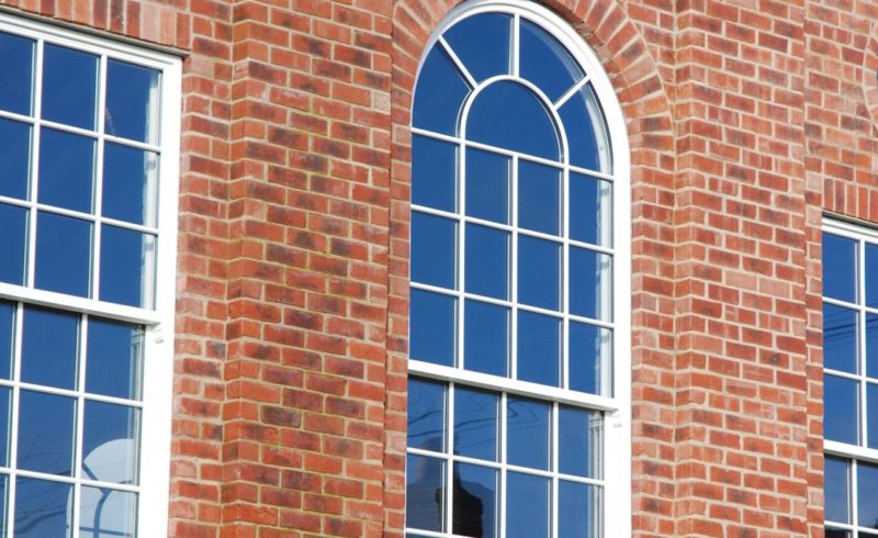 an arched spiral window made from sustainable wood by Gowercroft