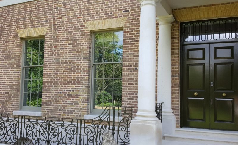 double glazing on a rich looking house with timber windows and impressive double wooden doors in london