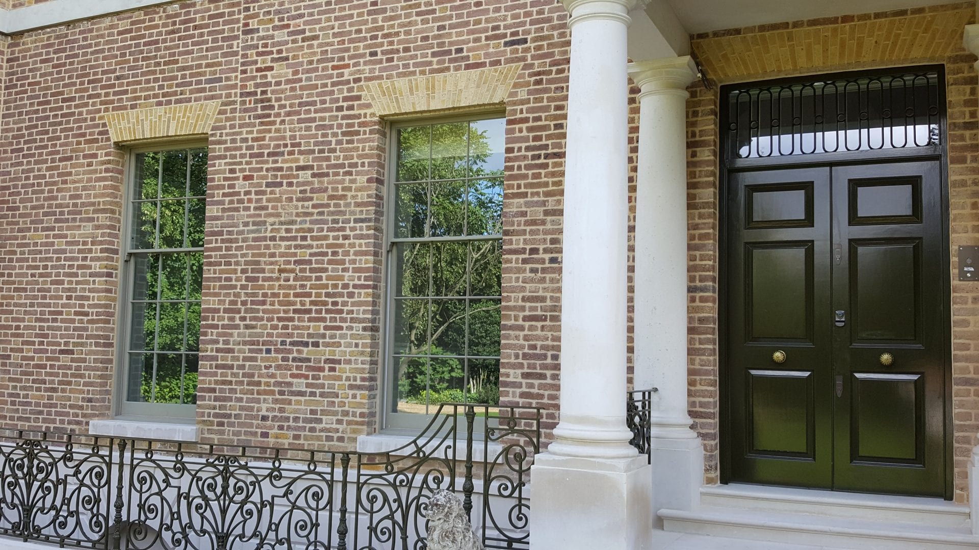 double glazing on a rich looking house with timber windows and impressive double wooden doors in london