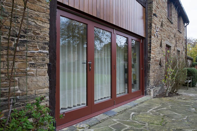 Heritage bifold doors in barn conversion from outside by Gowercroft