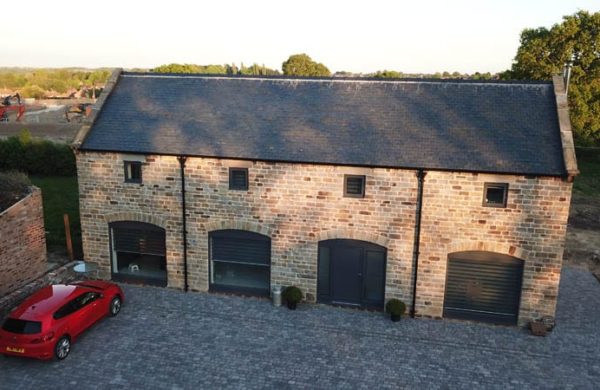 High elevation shot of Duston Barn with clear views of the Hardwick Flush Casement Windows and Melbourne entrance Doors