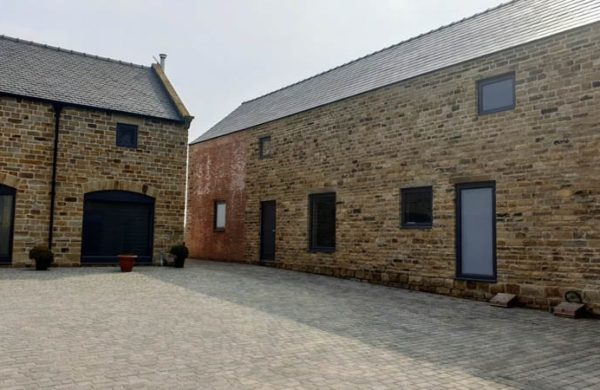 The main courtyard at Dunston Farm showing the wide variety of windows and doors for barn conversions