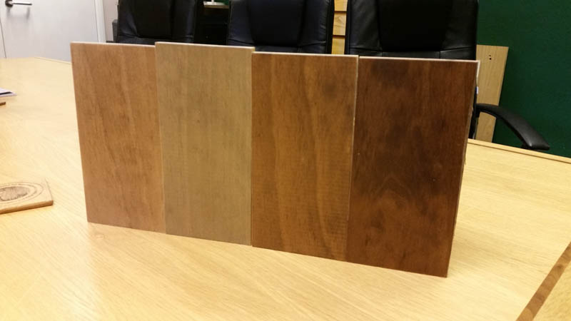 Accoya window frame stain samples on a desk in the Gowercroft office