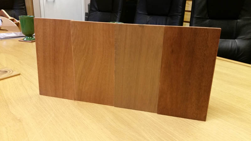 Red Grandis window frame stain samples on a table in the Gowercroft Office