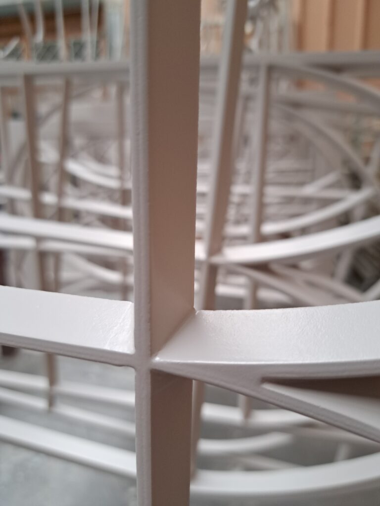 A close-up view of white integrated conservation bars for timber windows. The image shows a detailed intersection of the bars, highlighting their precise construction and smooth finish.