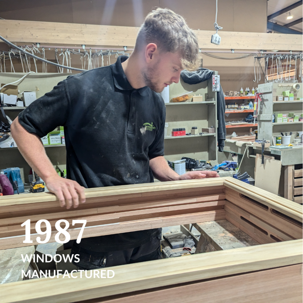 A Gowercroft Joinery craftsman carefully assembling a wooden window frame, showcasing the production of 1,987 windows in 2024.