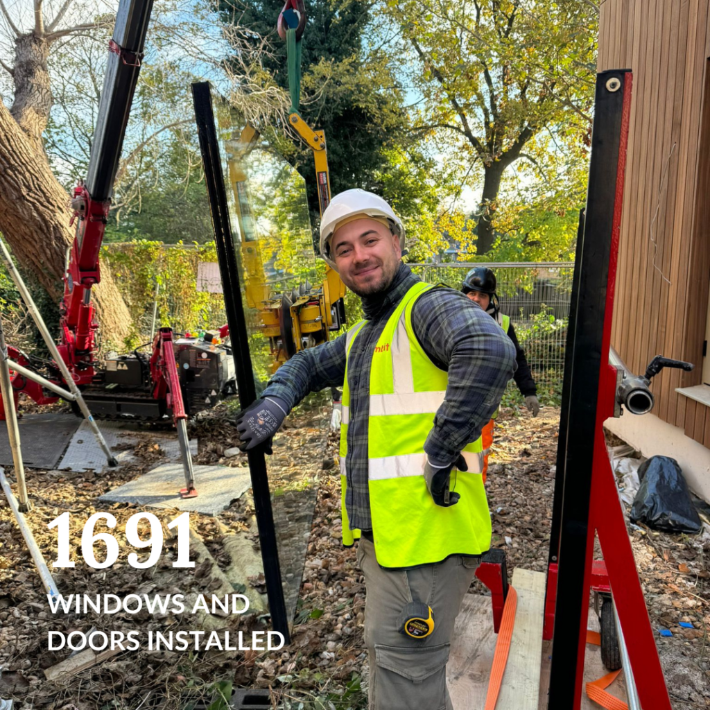 Gowercroft Joinery installer on-site, installing windows and doors, representing the completion of 1,691 installations in 2024.