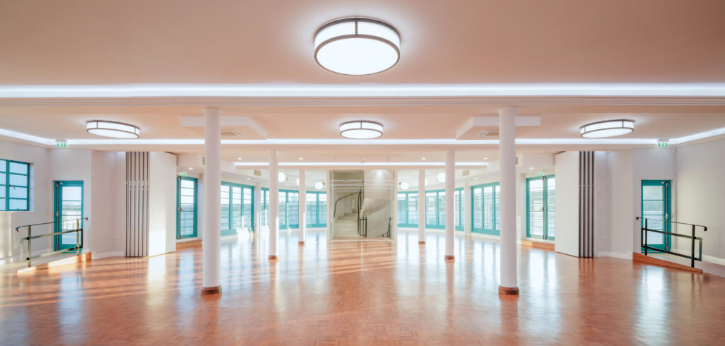 Internal Panorama of Curved Tutbury Bi-Fold Doors and Melbourne French Doors
A wide-angle interior view of Saltdean Lido’s event space, showcasing the curved Tutbury Bi-Fold Doors and Melbourne French Doors in turquoise. Natural light floods the room, highlighting the restored parquet flooring and period-accurate lighting.